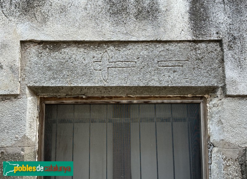 Sant Jordi Desvalls - Llinda del segle XVII amb símbols de mestre de cases (Foto: Albert Esteves, 2025) Sant Jordi Desvalls - Llinda del segle XVII amb símbols de mestre de cases
